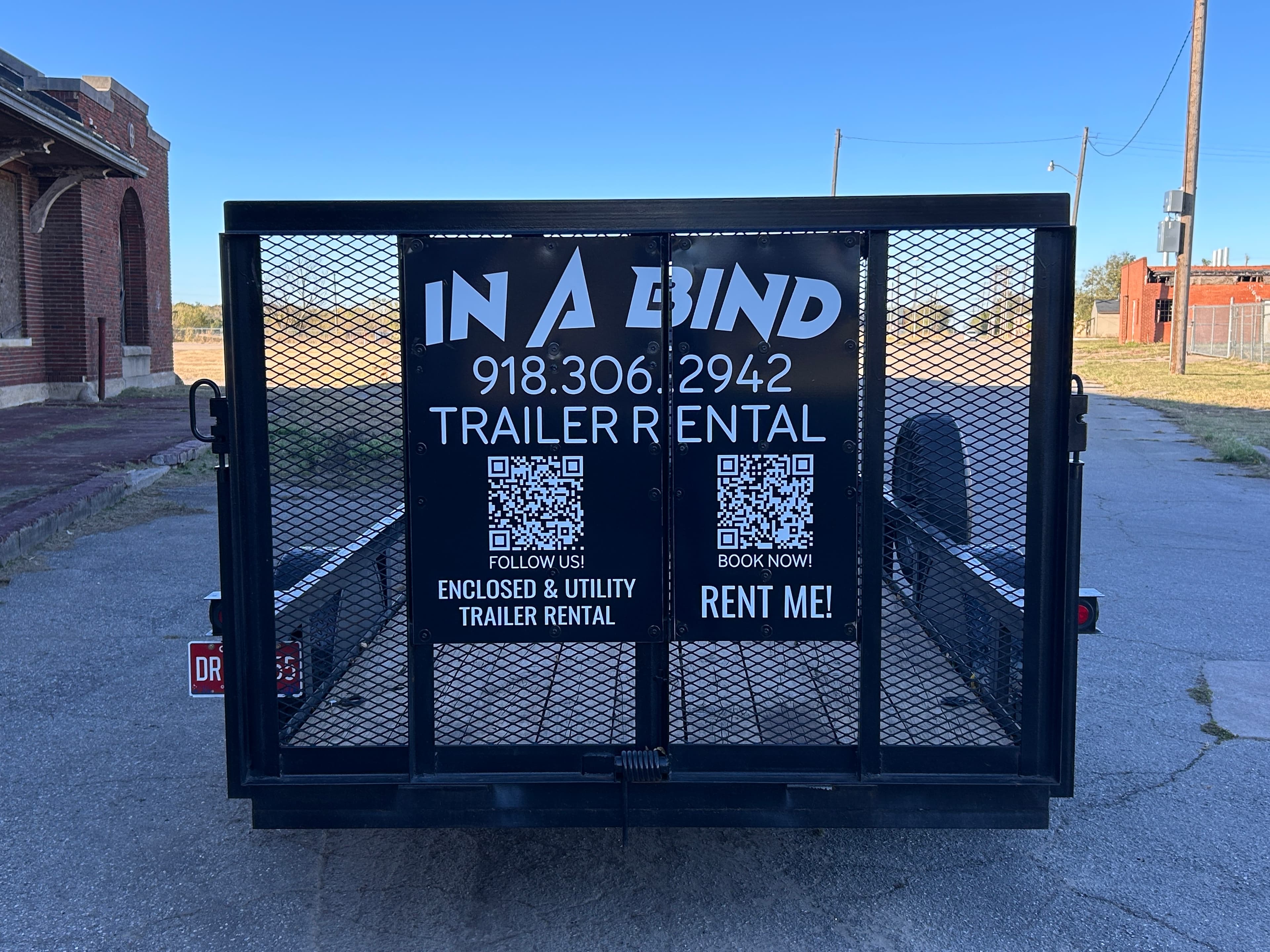 Open utility trailer rear view with ramp gate